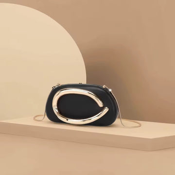 Black Oval Crossbody Bag with Bold Gold Accent